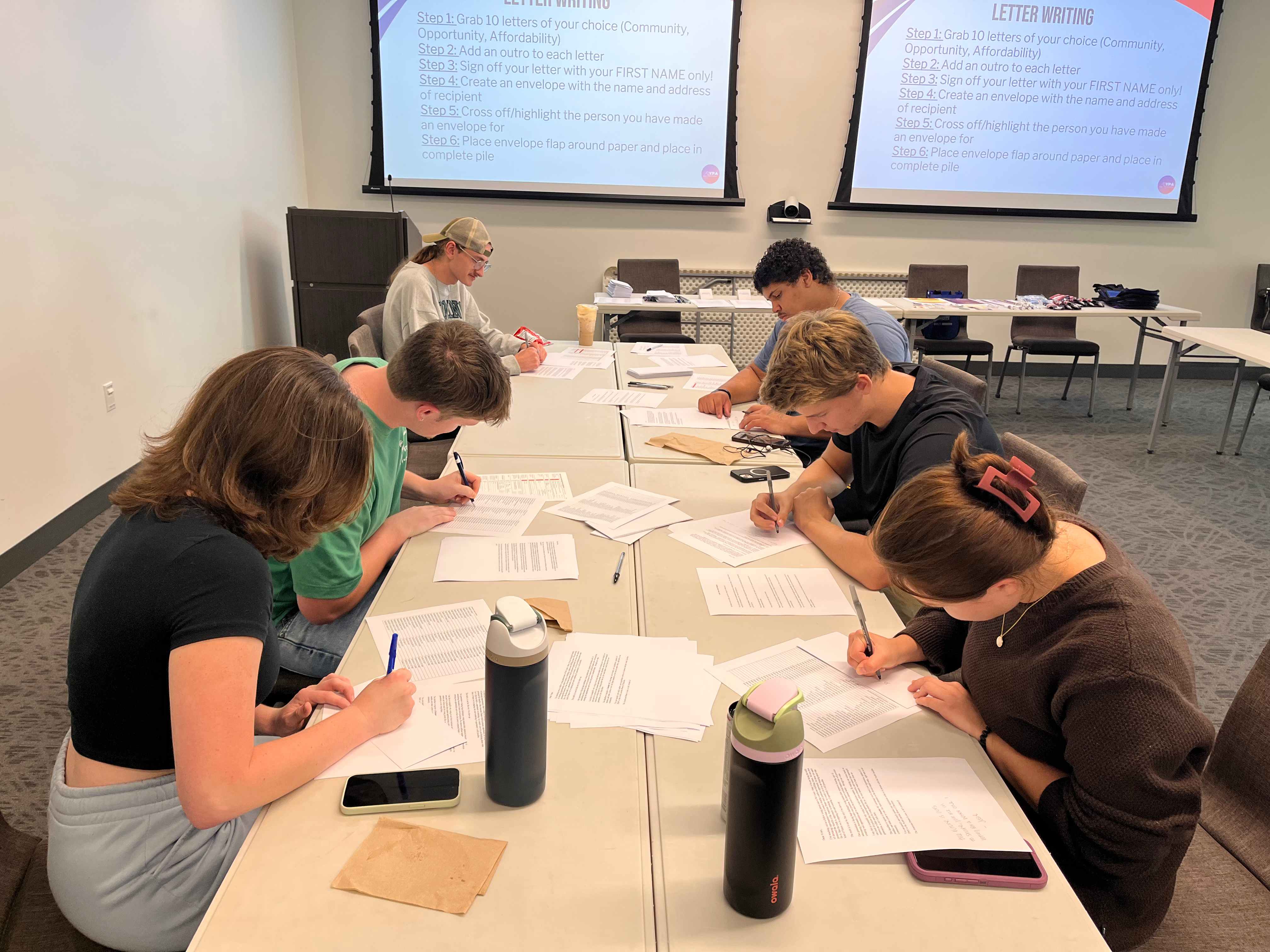 YPA members writing letters at a workshop table