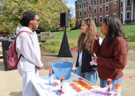 YPA student organizers talking to peers at campus voter registration event
